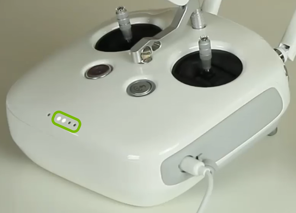 Battery charge level indicator lights highlighted on remote control.