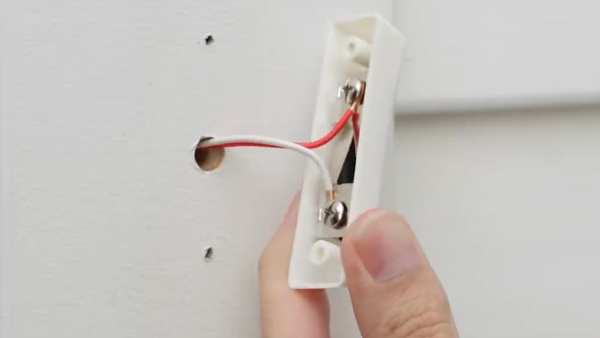 Pulling doorbell forward.