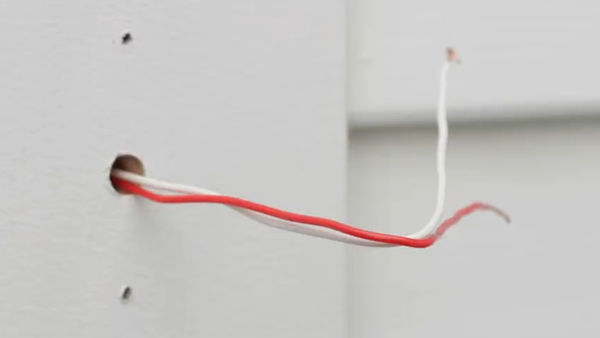 Doorbell removed, wires bent to prevent slipping.