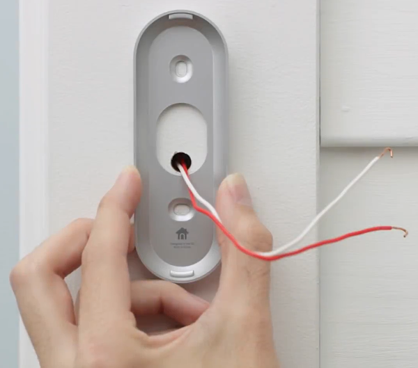 Holding the bracket in position.