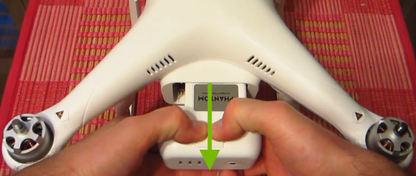 Pulling the battery out of the drone.