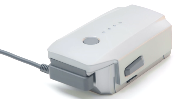 Charging cable plugged into drone battery.