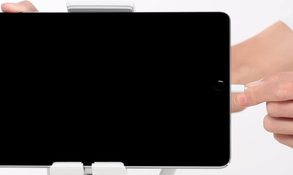 USB cable being plugged into tablet.