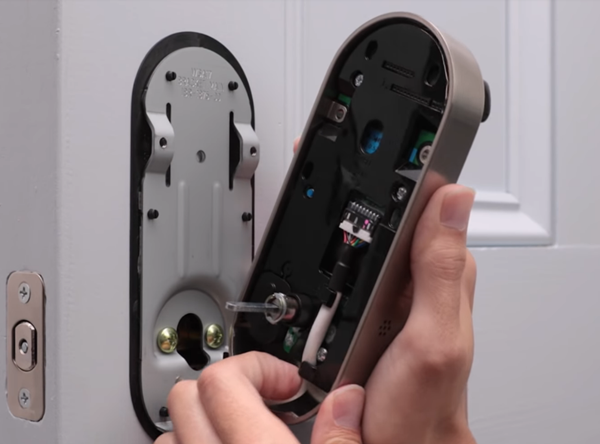 Routing the cable behind cable hooks. Illustration.