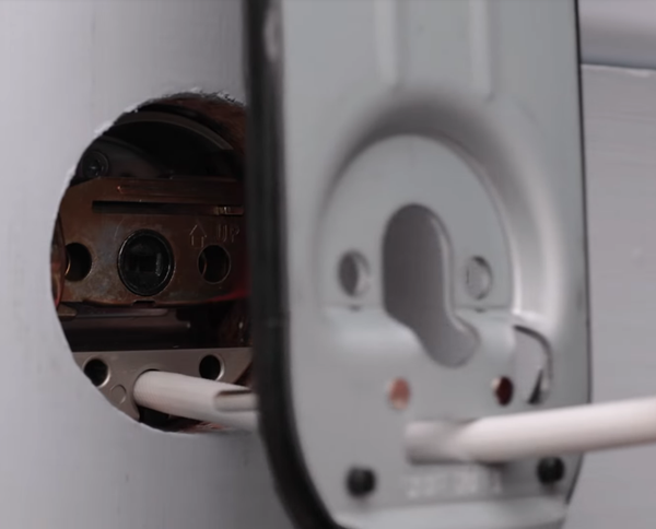 Lining up mounting plate pins with holes. Illustration.