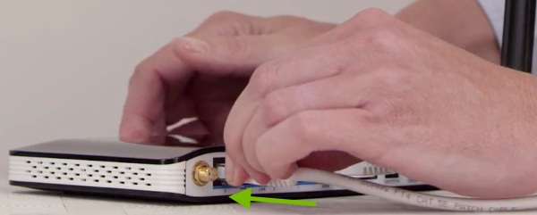 Cable being plugged into router.