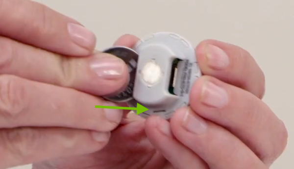 Battery being inserted in dimmer body.