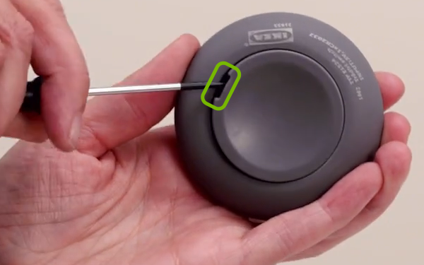 Back cover being removed from remote control.