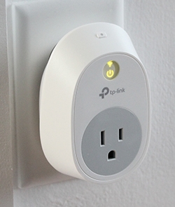 Smart plug connected to power and Wi-Fi light turned on.