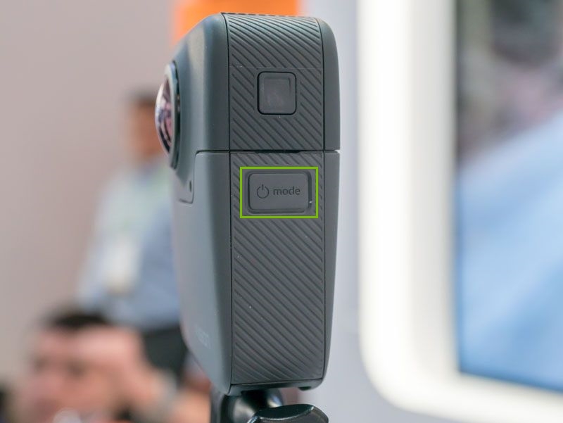 GoPro Fusion camera with Mode button highlighted on the side.