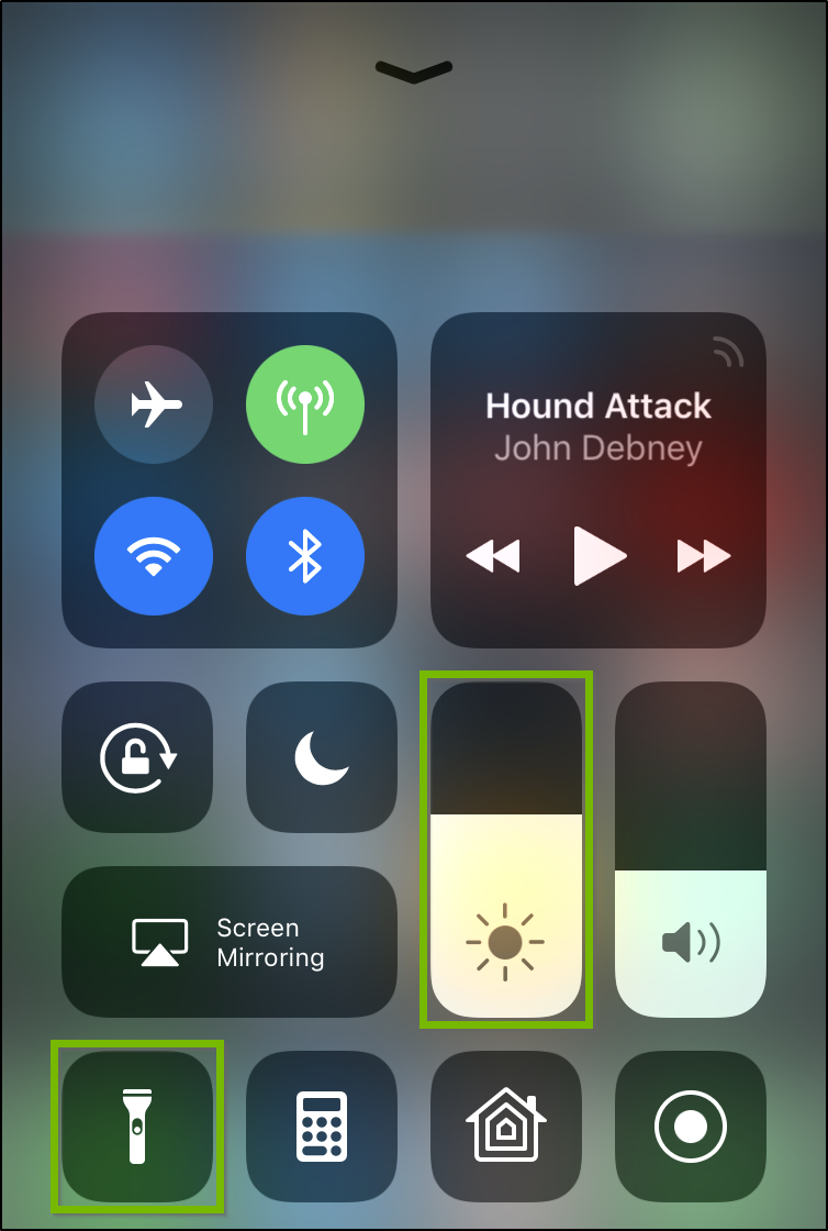 iOS Control center highlighting flashlight button and brightness slider.
