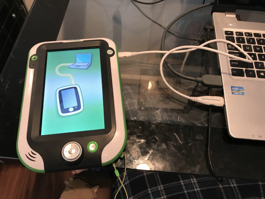 LeapPad Ultimate connected to a laptop via USB cable.