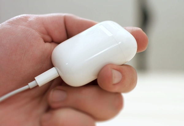 USB power adapter connected to AirPods case.