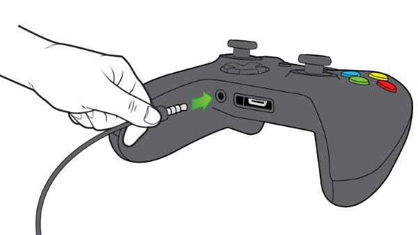 Chat headset being plugged into controller.