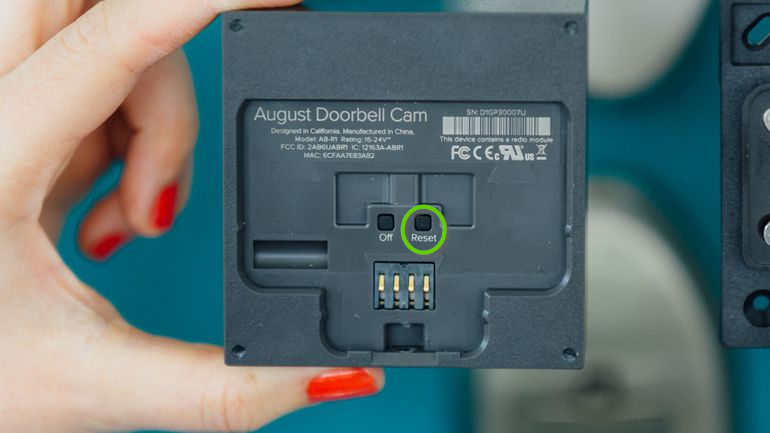 Back side of the August doorbell cam highlighting the reset button.