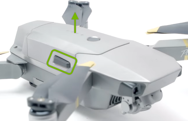 Battery side buckle highlighted and arrow pointing release direction.