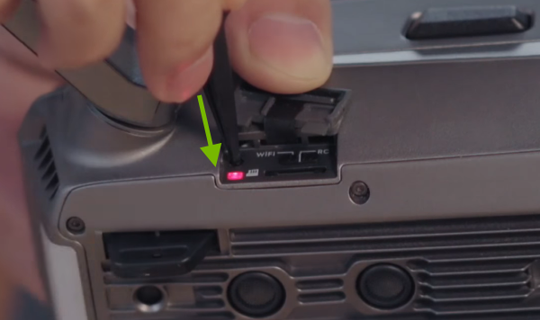 Link button being pressed on right side of drone.