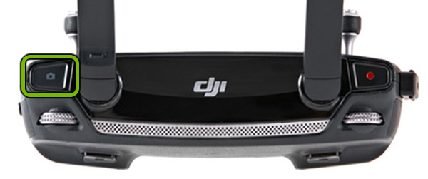 Shutter button highlighted on right shoulder of remote control.