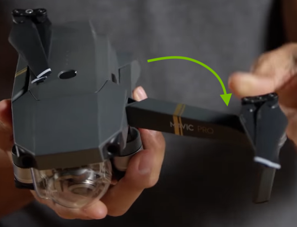 Arrow showing front arm unfolding direction.