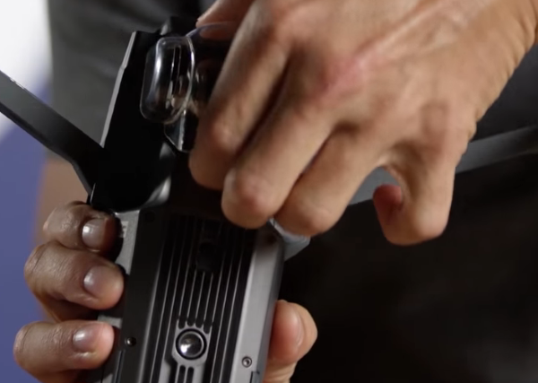 Gimbal cover being removed from drone.