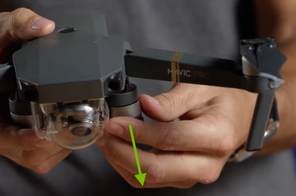 Arrow showing rear arm unfolding direction.