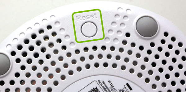 Reset button highlighted on bottom of ASUS Lyra hub.