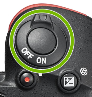Power switch highlighted on top of Nikon camera.