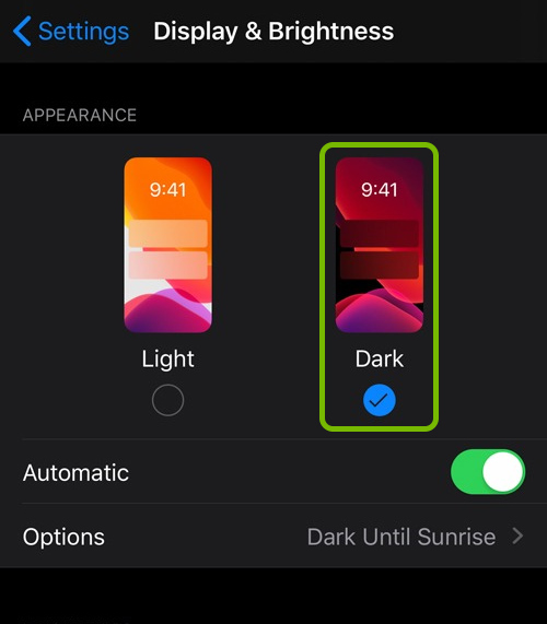 Dark mode highlighted in Display & Brightness settings on iOS.