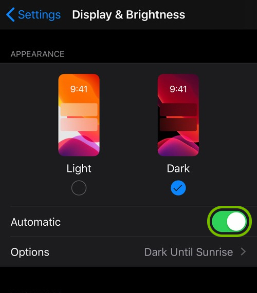 Automatic option toggle highlighted for Dark Mode in Display & Brightness settings in iOS.