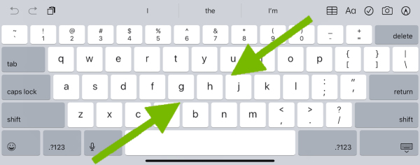 Arrows showing pinching motion on iPad on-screen keyboard.