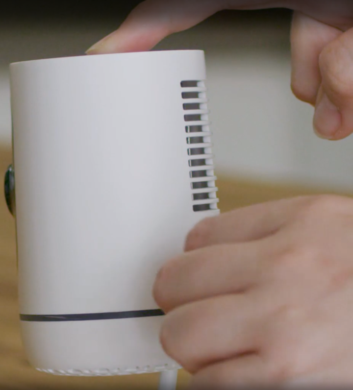 while holding down the button, plug the camera back in.