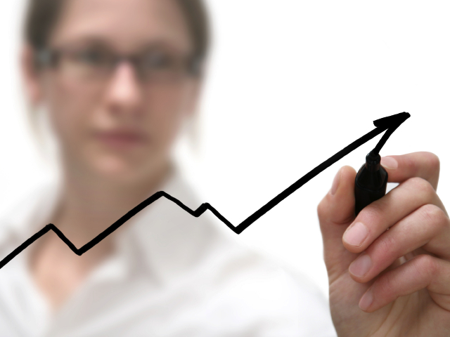 An employee drawing a graph going up.