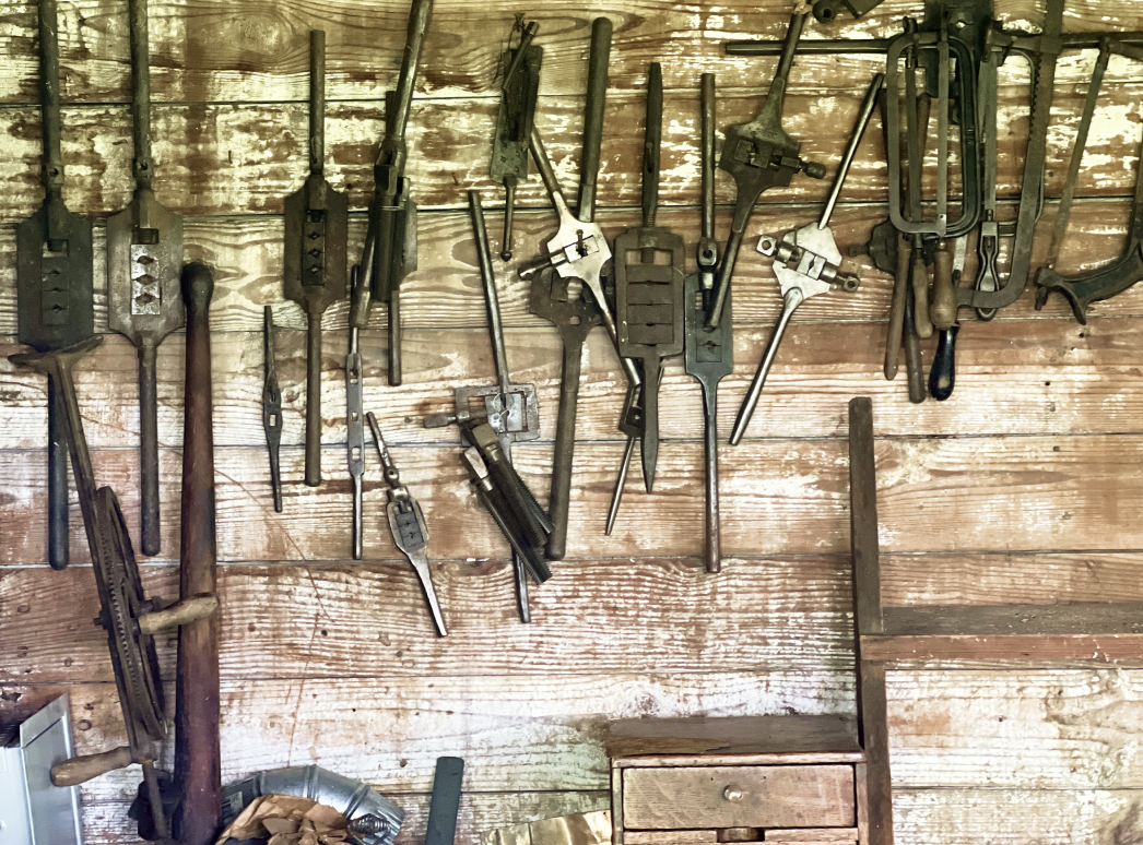 An image of tools hanging on the wall.