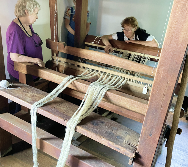 Two women working at the loom in a workshop at Kilts Farm.