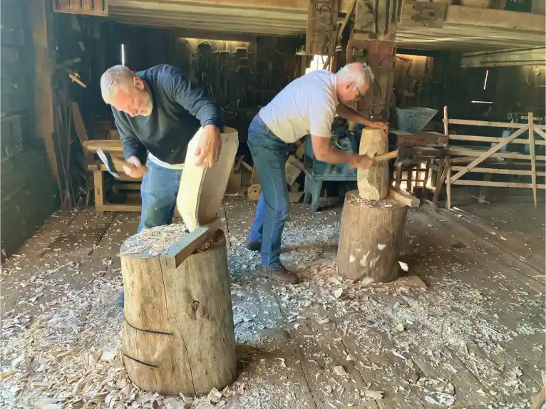 Two men doing woodworking during a workshop at Kilts Farm.