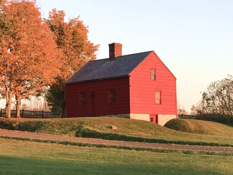 An image of the red barn up on the hillside in the fall.