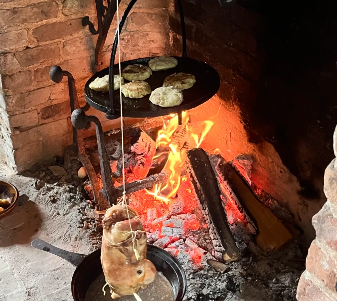 Food being cooked over an open fire at the 2025 Open House at Kilts Farm.