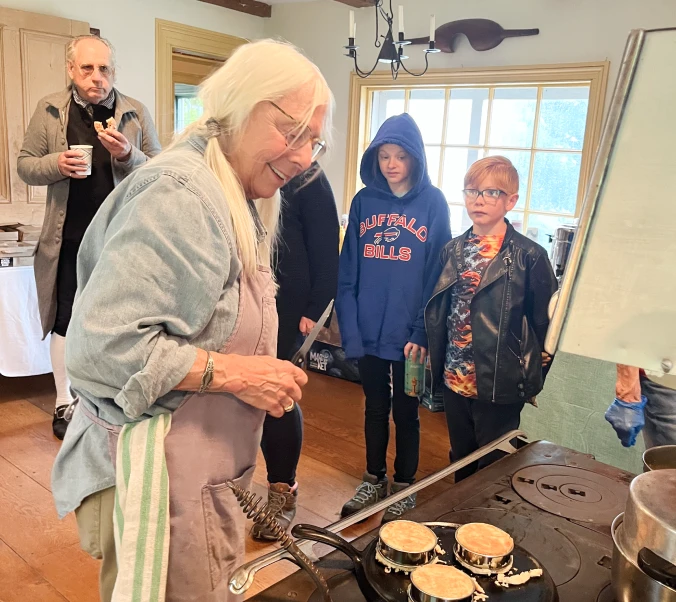 A picture of a demonstrator cooking at the 2025 Open House.