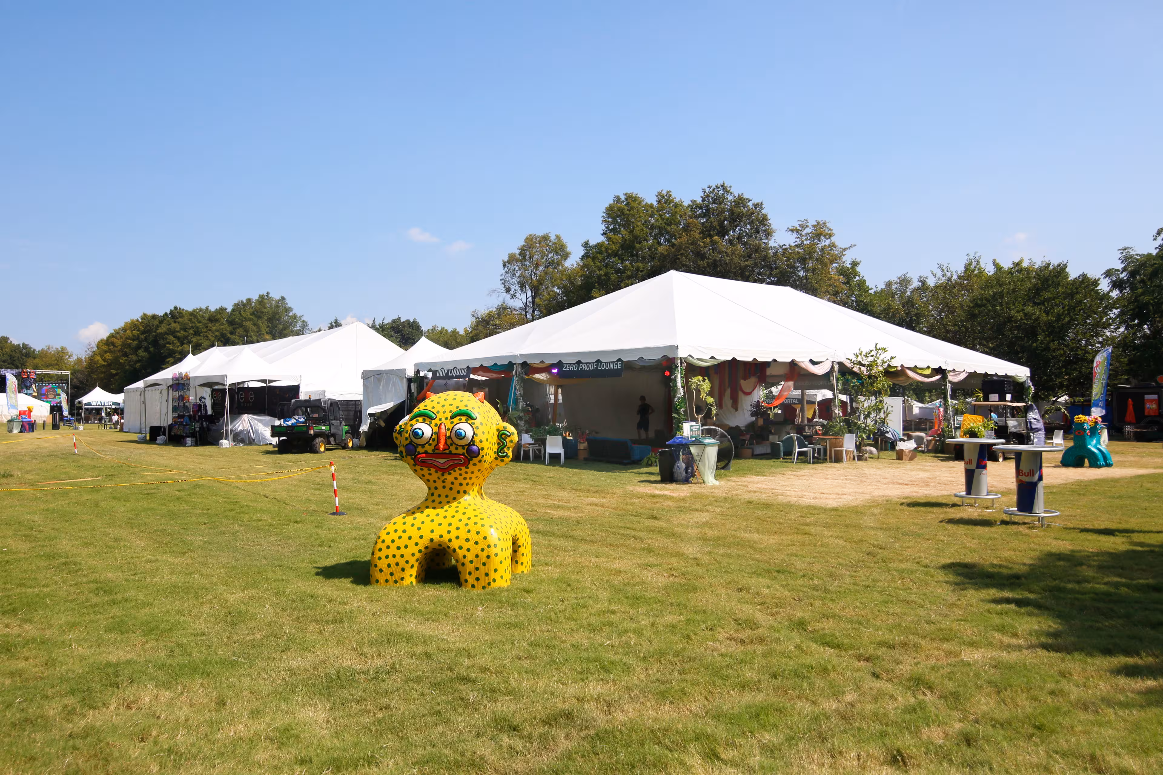 Large yellow duck in front of a tent provided by Grand Tents & Events for the Deep Tropics Festival in Nashville TN