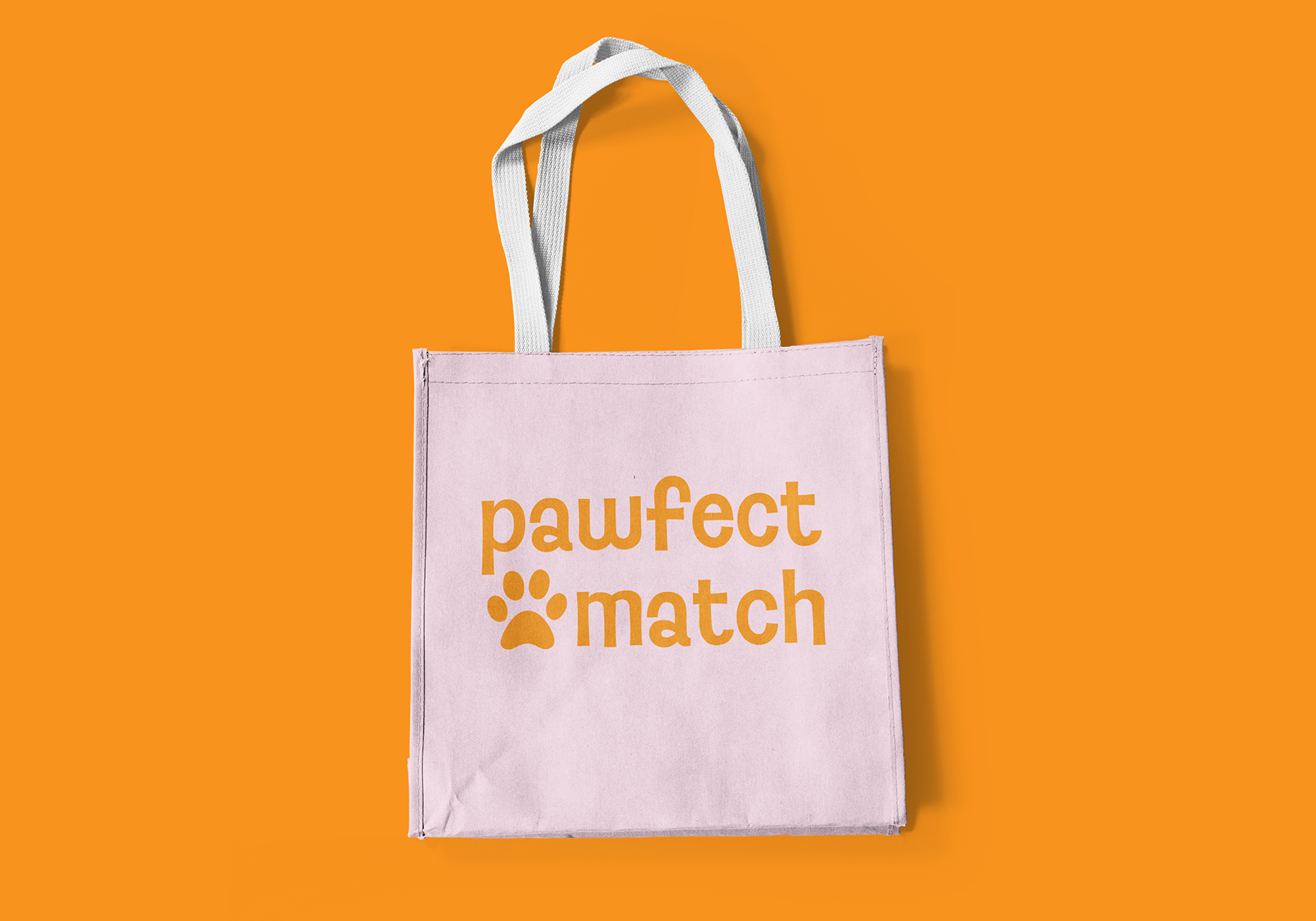 Pink tote bag with logo on orange background