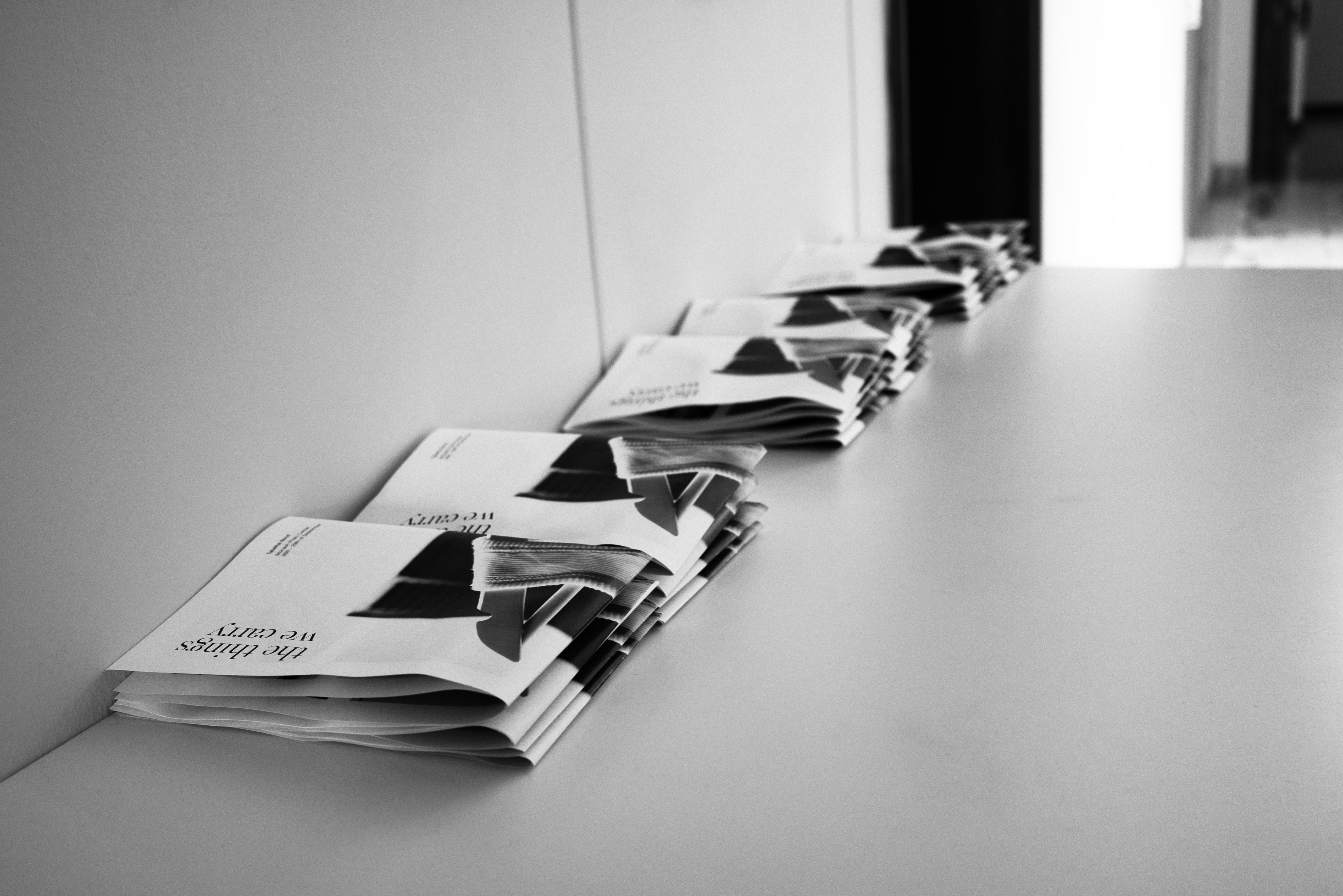 Black and White image: Hallway table with brochures