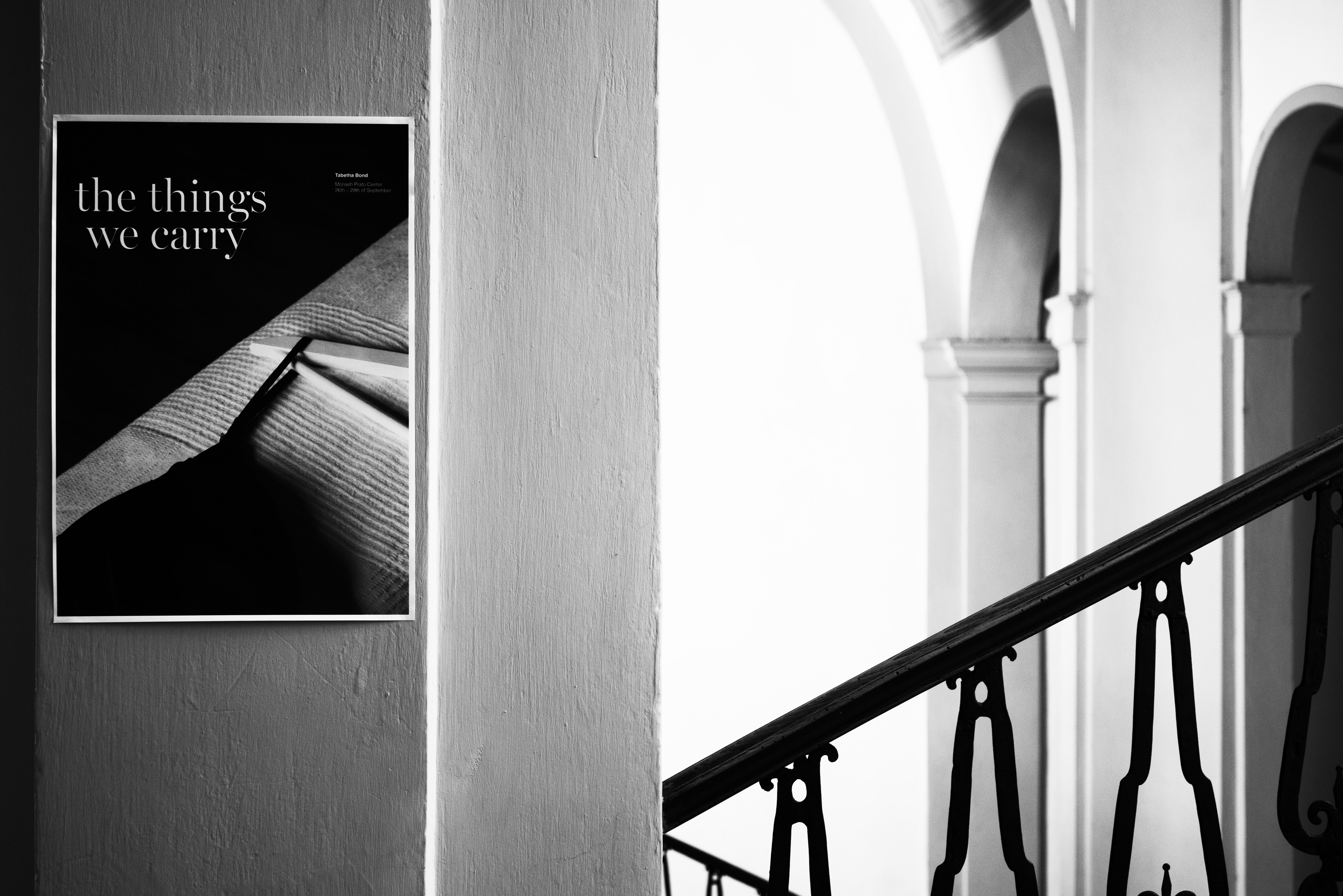 Black and White image: Poster on wall inside building 