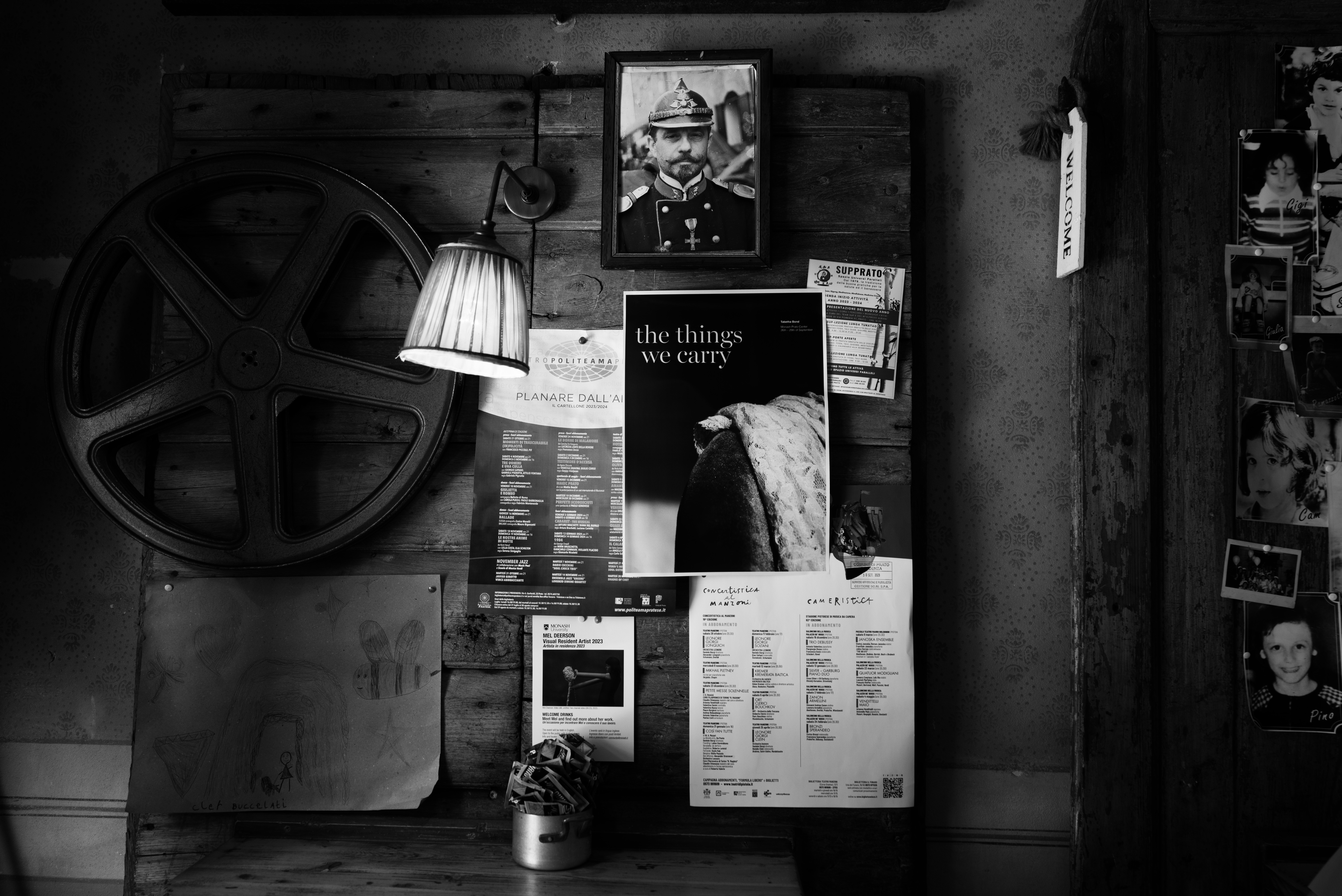 Black and White image: Poster on wall inside cafe notice board