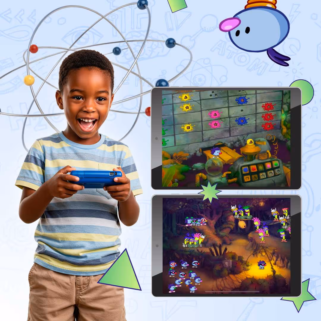 Smiling boy holding game controller with Zoombinis gameplay on two tablets beside him.