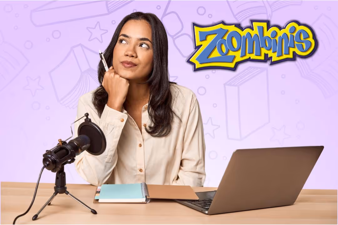 Woman sitting at desk with microphone, notebook, and laptop, looking thoughtful with Zoombinis logo in background.