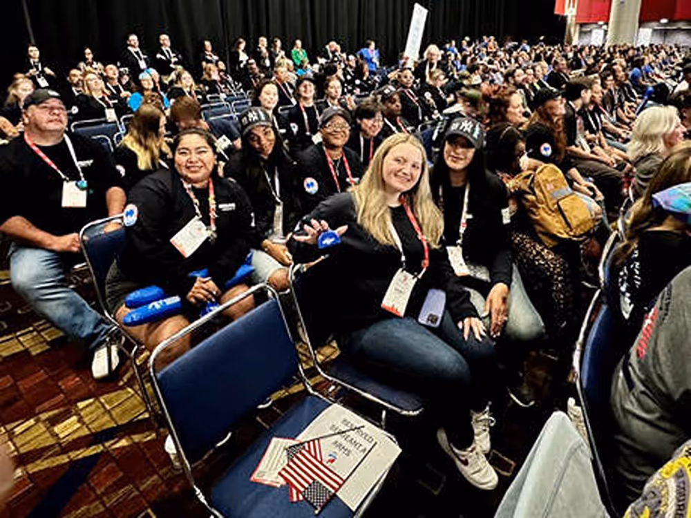 Local 28 Women’s Committee members seated together at the September 2025 Tradeswomen Build Nations Conference in Chicago, surrounded by fellow attendees.