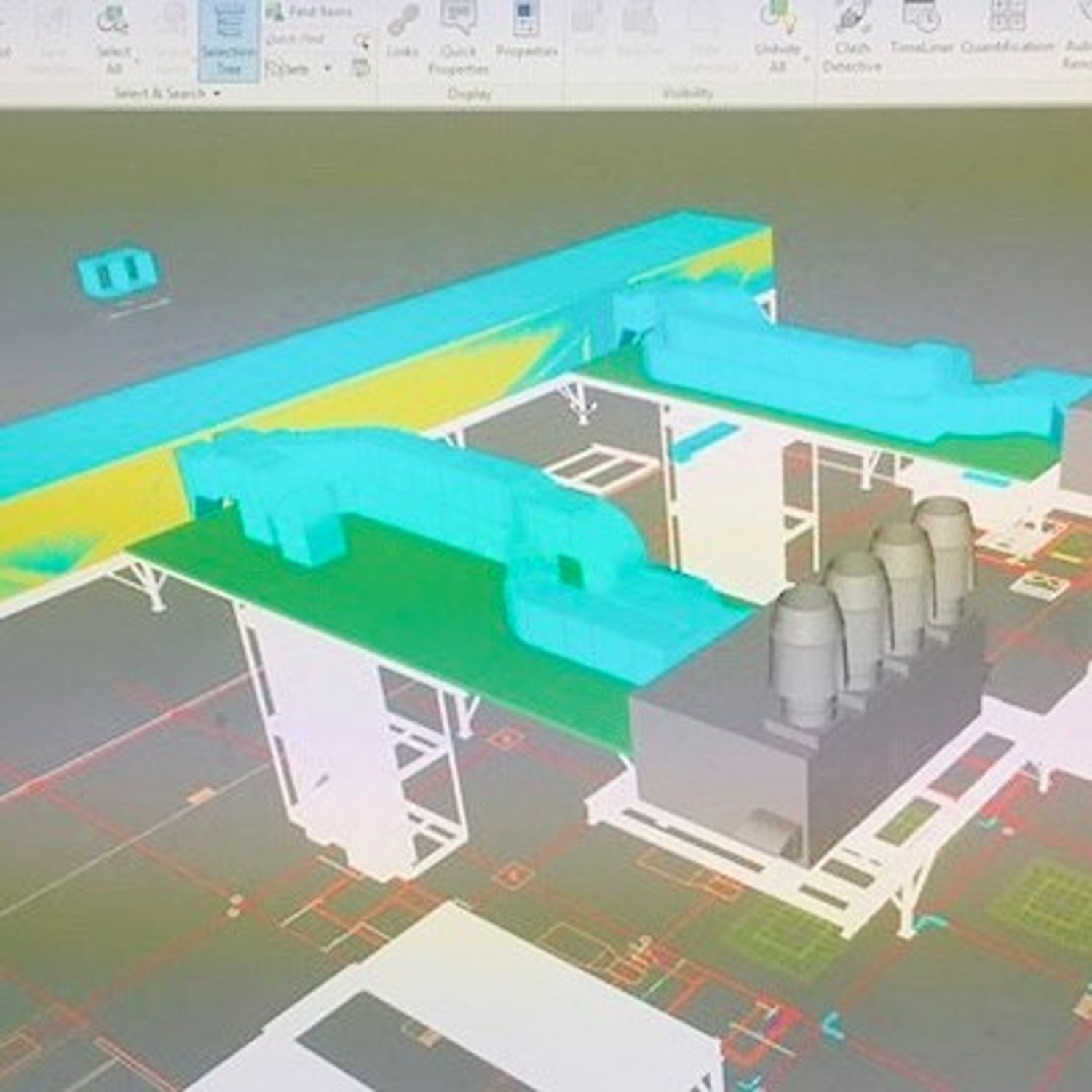 3D digital model of an industrial facility with large pipes in blue and cylindrical structures in grey on a schematic floor plan background.