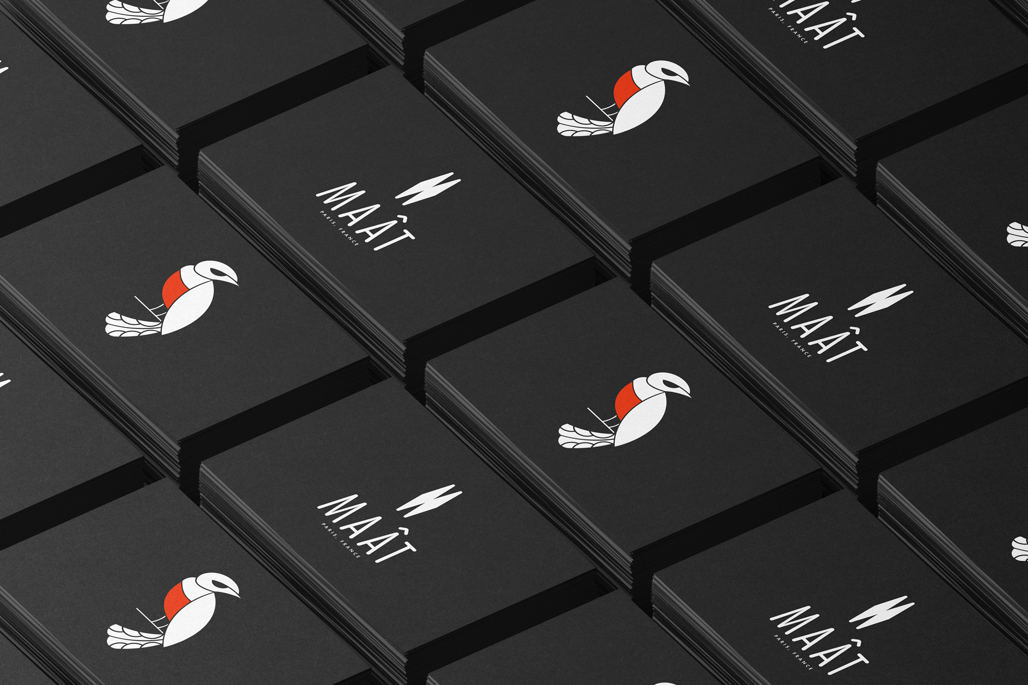 Black business cards featuring the Maât brand identity with a minimalist bird illustration and custom logotype, arranged in a grid layout. Overlay text reads “Maât – Brand Identity for a Lifestyle Label.”
