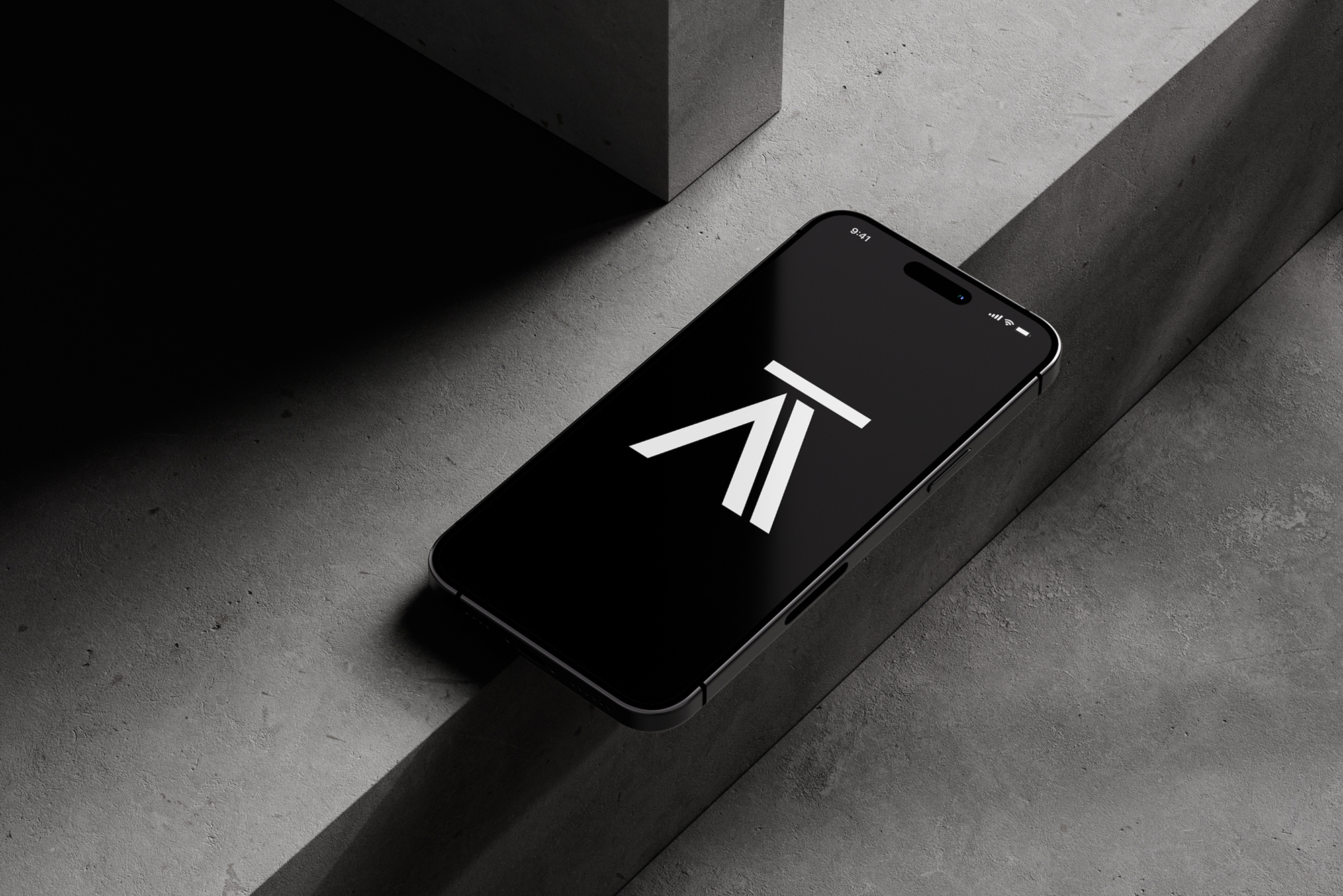 Black smartphone displaying the A-Theory logo on screen, placed on a minimal concrete surface. Overlay text reads “A-Theory – Visual Identity for a Consulting Firm.”