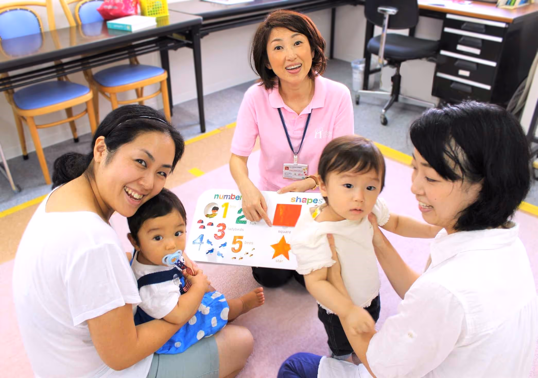 The teacher reading a book to students in baby step